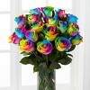 Rainbow-colored roses in a clear glass vase