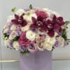 Lavender and white rose bouquet with deep magenta orchids in a round box