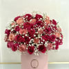 Bouquet of pink and red roses with baby's breath in a pink box