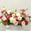 Pink and white floral arrangement in a white bowl vase