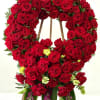 Large red rose funeral wreath on a wooden easel