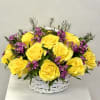 Yellow roses and purple filler flowers in a white basket