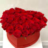 Heart-shaped box filled with red roses