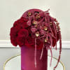 A luxurious blend of deep red roses and rich burgundy orchids, accented