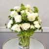 White roses and dahlias arranged in a clear glass vase