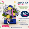 Blue crayon box arrangement with purple and yellow flowers and a ribbon