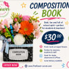 Flower arrangement in a composition book-shaped container with a ribbon bow
