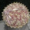 Large round bouquet of pale pink and white roses with a pink ribbon