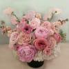 A medium sized beautiful arrangement placed in a 5" by 5" vase
