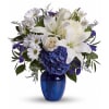 White lilies, daisies, and blue hydrangea in a cobalt vase