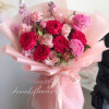 The Vivid Romance Bouquet is a captivating ensemble of radiant hot pink