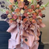Large bouquet of peach and pink roses with ribbon and wrapping