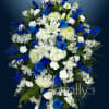 Blue and white funeral spray with lilies and chrysanthemums