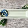 Rectangular white serving tray with a small decorative succulent and flip-flop accents