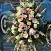 Tall floral spray with pale pink roses, white calla lilies, and pink accents