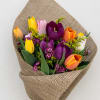Bouquet of multicolored tulips wrapped in burlap