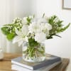 An elegant all-white bouquet featuring lilies, chrysanthemums, and delicate seasonal blooms, beautifully