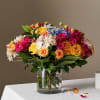 Mixed bouquet of roses and small white flowers in a glass vase