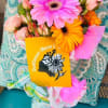 Bouquet of pink and orange gerbera daisies with pale roses and a card