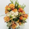 A lively blend of orange and white roses gives this flower arrangement