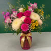 Bouquet of pink roses, chrysanthemums, and alstroemeria in a pink vase