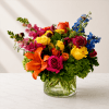 Colorful mixed bouquet in a clear glass vase with roses and lilies