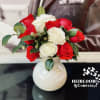 Bouquet of red and white roses in a white vase