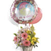 Basket of pink and yellow flowers with a "it's a Girl!" balloon