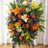 A bold, ceremonial standing spray that makes a vivid, uplifting statement -
