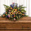 Bright, garden-fresh and abundantly sympathy spray. Sunflowers and coral-pink roses create a