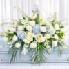 A serene, large low arrangement in soft blue and white that reads