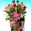 Deep red roses rising in a tall, elegant cluster meet large pink