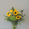 A vase of sunflowers and roses with white accents