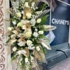 Tall white and gold floral standing spray with roses and lilies