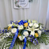 An elegant and moving floral casket arrangement, designed with love using a