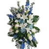 Tall white and blue floral standing spray with lilies and roses
