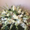 Large white floral spray with roses, calla lilies, and daisies