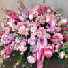 Large pink floral spray with roses, gerbera daisies, calla lilies, and a ribbon bow