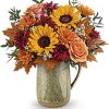 Like the autumn sun's warmth, this delightful sunflower bouquet is elegantly showcased