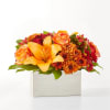 Step into autumn with fiery red and orange petals, expertly arranged to