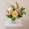 A refined, garden-style arrangement designed with a soft palette of ivory, buttercream
