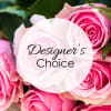 Pink roses with a "Designer’s Choice" label over the center