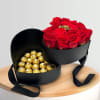 Heart-shaped box with red roses and gold-wrapped chocolates