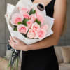 Bouquet of pale pink roses wrapped in white paper