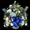 Blue and white floral standing spray with a large blue ribbon