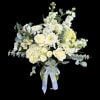 White roses and mixed white flowers in a glass vase with a ribbon