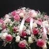 This beautiful casket spray made with  pink and white roses, white