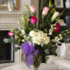 A tall, layered flower arrangement that reads elegant and romantic, perfect as