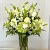 White and green bouquet in a clear glass vase