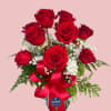 Bouquet of red roses with baby's breath in a glass vase and red ribbon
